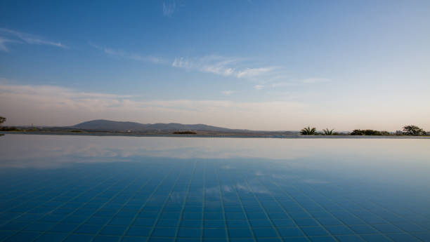 istock Mountains seen through the reflection of the infinity pool 1411283596