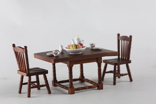 dollhouse interior - served tea table isolated on gray background. Image contains copy space