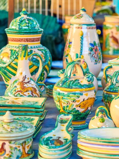 istock Different handmade ceramic pots for sale painted in green color 1411285982