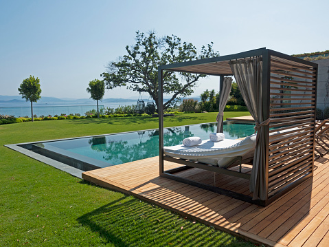 Outdoor swimming pool and Wood bed - chair in the pool with open sky.