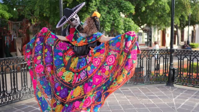 Couple dancing and celebrating the day of the dead outdoors