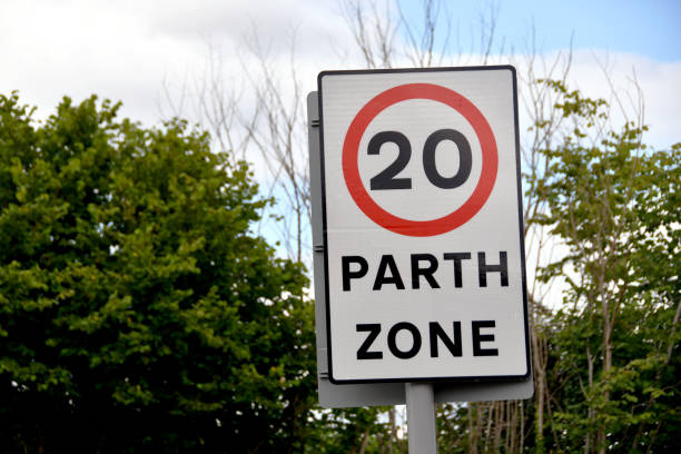 istock Road sign at start of a 20 mph speed limit zone 1411288024