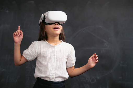 Back To School Concept, Happy Smiling Child Student Using VR Equipment And Attending Remote Education