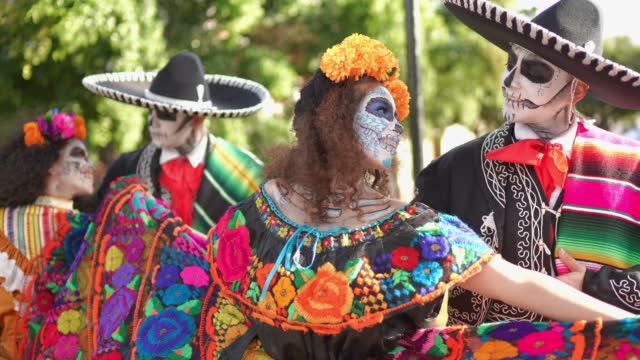 Group of friends happiness dancing and celebrating the day of the dead