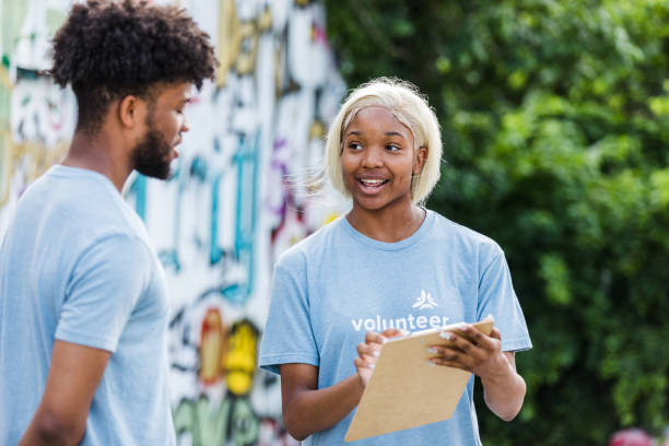 istock Female volunteer helps assign tasks 1411288716