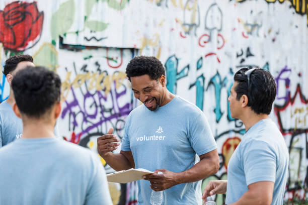 istock Male volunteer reads tasks off his clipboard 1411288745