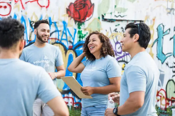 Photo of Family stands near the graffiti wall