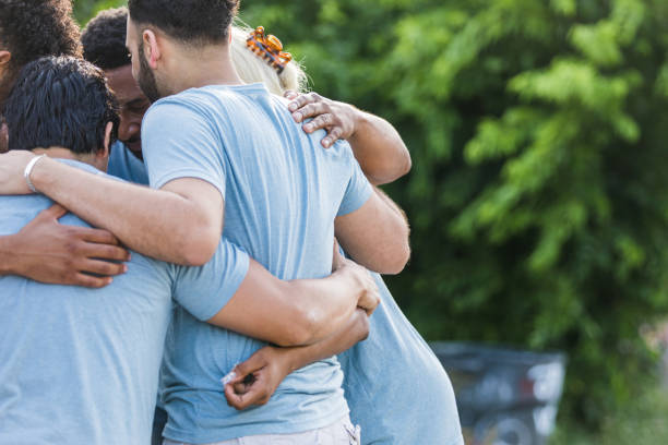 istock Off center photo of group hugging 1411288793