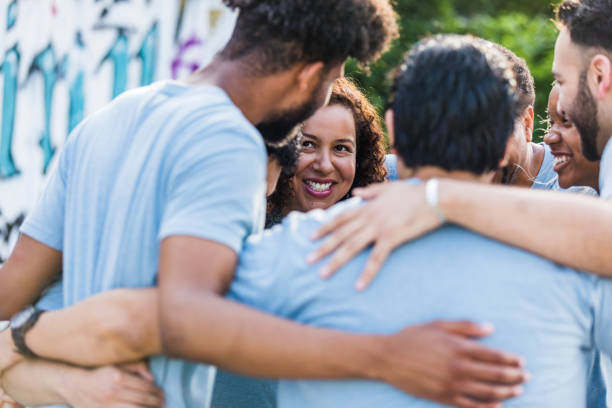 istock Diverse group of friends hug one another 1411288795