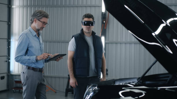 istock Mechanic in VR headset and manager together 1411289820