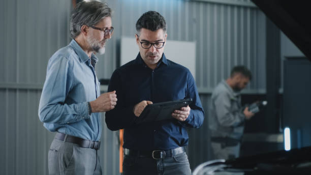 istock Car service manager talking to man 1411289856
