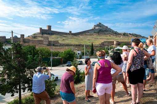 August 27, 2021. Ukraine Crimea, Sudak city Genoese fortress, editorial. The excursion group examines the fortress and the city.