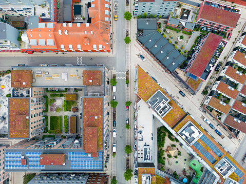 Top down drone images of the up class oceanfront at Nordhavn in Copenhagen, Denmark. The solar panels, plants and grass on the rooftops of these buildings support a sustainable lifestyle and rich biodiversity within this modern, capital city.