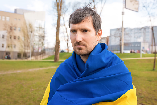 Outdoor portrait of a young Ukrainian male outdoors in the park. Free lifestyle concept.