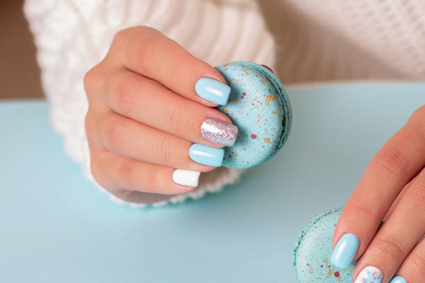 Female hand with blue manicure nails