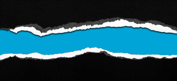 istock Ripped black paper on blue 1411294600