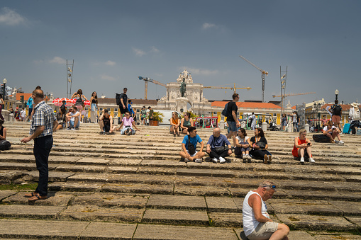 Lisbon,Portugal : July 4,2022- The Rua Augusta Arch square historical building in Lisbon, Portugal, on the Praça do Comércio Commerce Square packed with tourist enjoying the view and soaking the sun