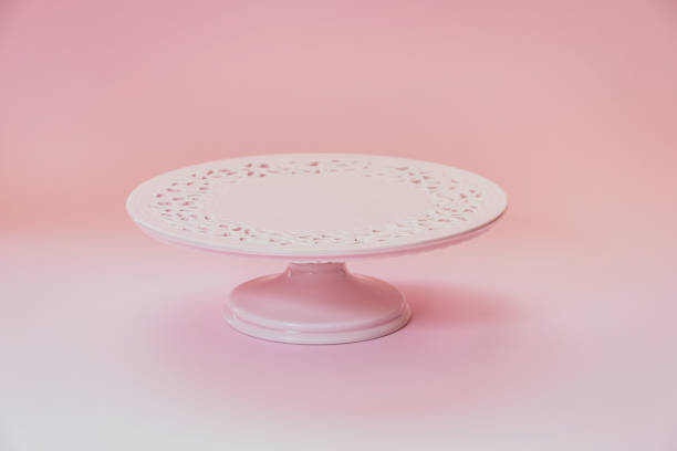 istock Empty  ceramic pink cake stand on a pastel pink table with copy space, selective focus 1411297000