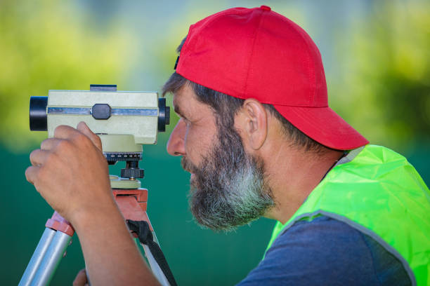 istock A man works with an optical level to level the landscape. 1411297682