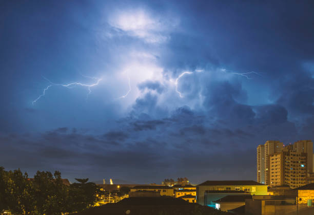 istock Lightning strikes in the night city sky. 1411300523