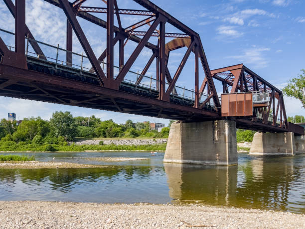 old rail bridge and dike trail on grand river, brantford, canada - ontario spring bicycle city life imagens e fotografias de stock