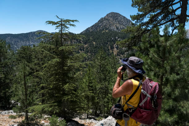 istock Backpacking man taking pictures in nature 1411302677