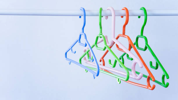 istock Colorful clothes hangers in empty wardrobe, closeup 1411303546