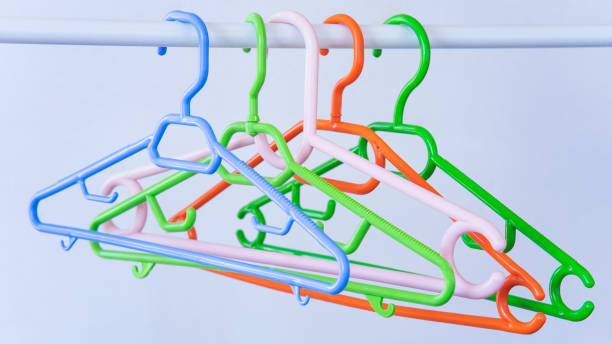 istock Colorful clothes hangers in empty wardrobe, closeup 1411306244