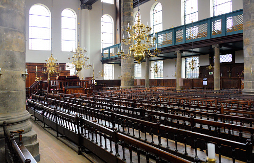 Amsterdam, The Netherlands: Portuguese Synagogue (the Esnoga / Snoge) - 17th-century Sephardic temple - the interior is of the longitudinal Iberian-Sephardic type, the dark wood benches came from an earlier synagogue built in 1639, these are arranged in two halves, facing each other across a central aisle, the women’s gallery is supported by twelve stone columns - brass chandeliers provide light from candles, no electrical power is used.