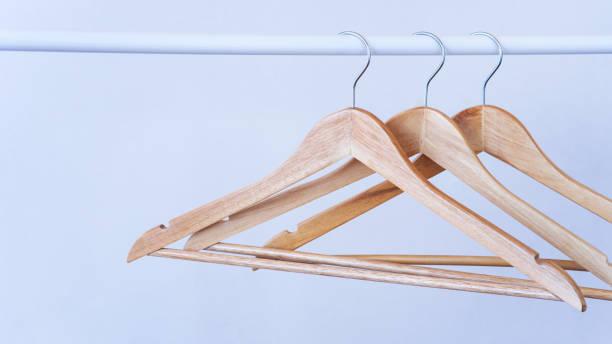 istock Clothes hangers in empty wardrobe, closeup 1411308411