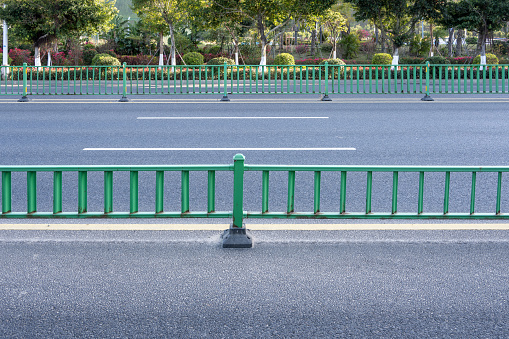 Asphalt roads and green guardrails in cities