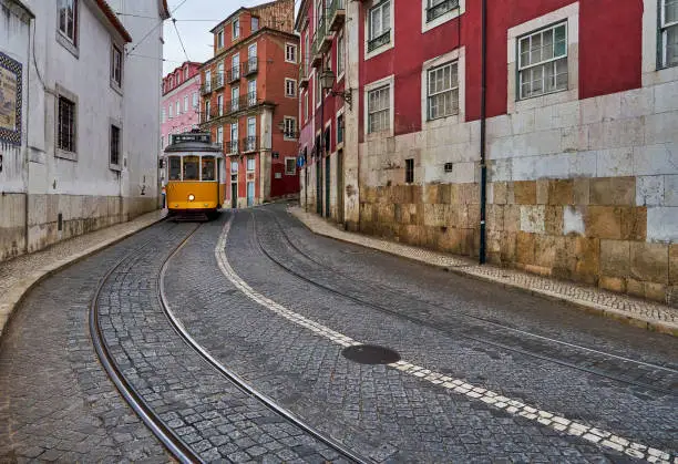 A street care moves through the scenic Alfama lookout area in LIsbon, Portugal.