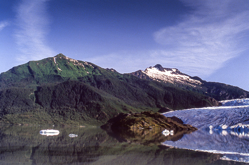 Distant view of Southeast Alaska's Mendenhall Glacier, as it slowly moves down Mendenhall Valley.\n\nTaken in Mendenhall Valley near Juneau, Alaska, USA