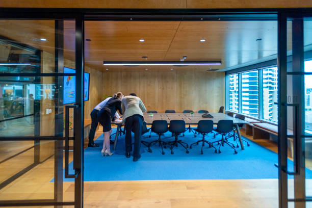 istock Rear view of Business people working on a laptop computer in a modern office 1411316264