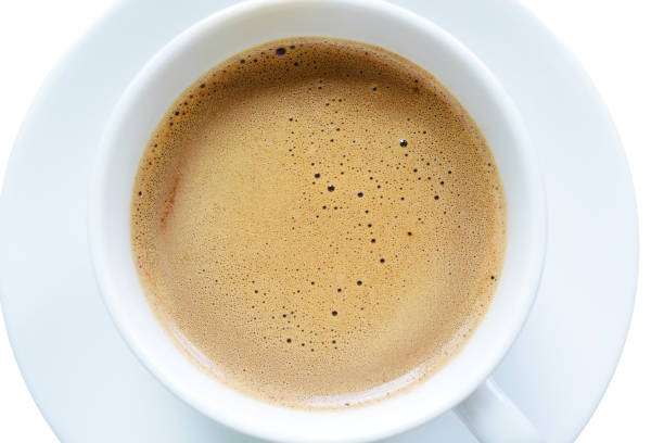 istock Coffee bubbles in white coffee mug close-up, top view, isolated on white. 1411316403
