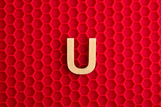 istock Capital letter U - White piece on silicone background with red hexagons 1411316453