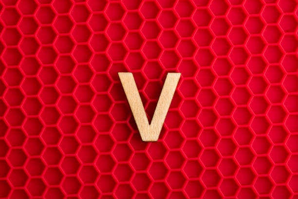 Capital letter V - White piece on silicone background with red hexagons