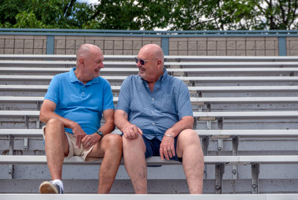 istock Mature gay couple in an empty stadium 1411318114