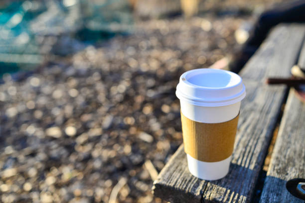 Coffee paper cups on wood table in coffee shop.