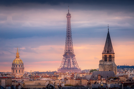 Eiffel tower and parisian roofs at dramatic sunrise Paris, France