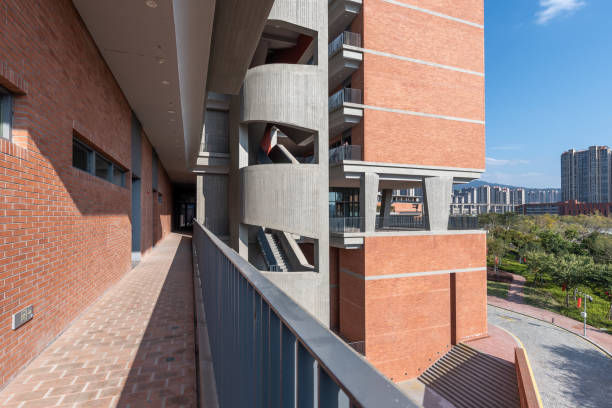 istock Sunlight reflected in the corridor of modern red brick buildings 1411322724
