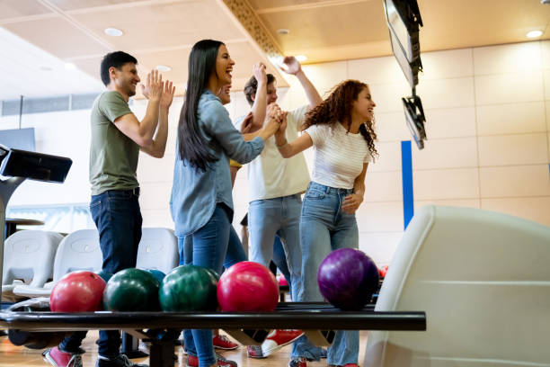 istock Group of friends looking very happy bowling 1411322770