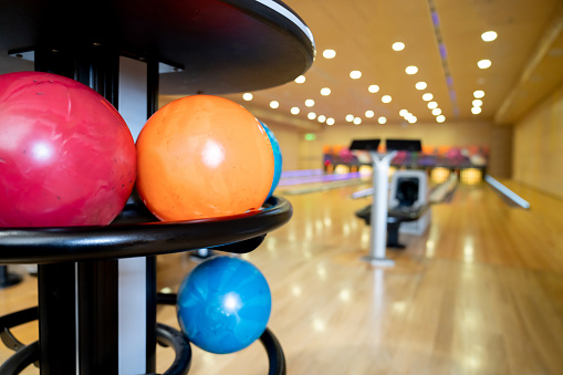 Close-up on bowling balls at the alley - sports and recreation concepts