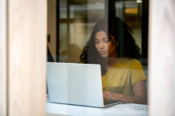 istock Beautiful business woman using a computer while working at a coworking office 1411322787