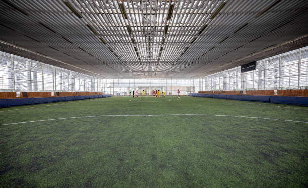 istock Co-ed teams playing a game at an indoor soccer field 1411322799