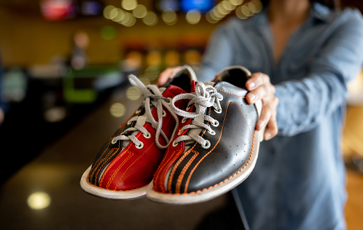 Close-up on bowling shoes for rent - sports and recreation concepts