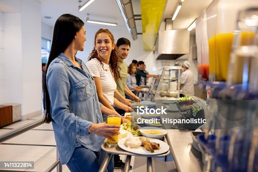 istock Happy women eating at a buffet style cafeteria 1411322814