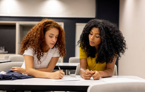istock Young female entrepreneurs working together on a project and writing on some documents 1411322839