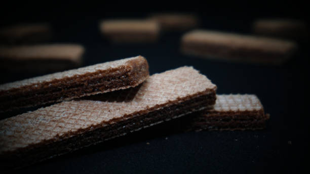 istock Sweet wafers on black background 1411323103