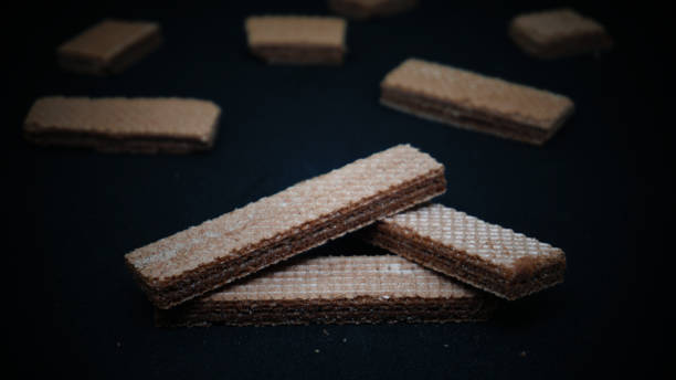 istock Sweet wafers on black background 1411323659